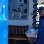 Rich Mattson approaches the large aquarium in the Ladd Macaulay Visitor Center on Dec. 24, 2018. For the past three decades, Mattson has maintained the aquariums in the center. (Ben Hohenstatt | Capital City Weekly)