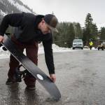 Scott Baxter preps his snowboard before the Hooter Lift opened at Eaglecrest on Monday, Dec. 17, 2018. (Michael Penn | Juneau Empire)