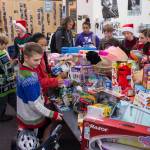 Floyd Dryden Middle School student council members gather around toys collected during a drive for Christmas presents to children in need at FDMS on Monday, Dec. 17, 2018. The toys and gift cards were handed over to the Alaska Department of Health and Social Services Office of Children Services for distribution. (Michael Penn | Juneau Empire)