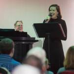 Juneau Cabaret singer Allison Holtkamp sings for Juneau residents as she is accompanied by Tom Locher during the third annual Holiday Extravaganza at Centennial Hall on Wednesday, Dec. 19, 2018. (Michael Penn | Juneau Empire)