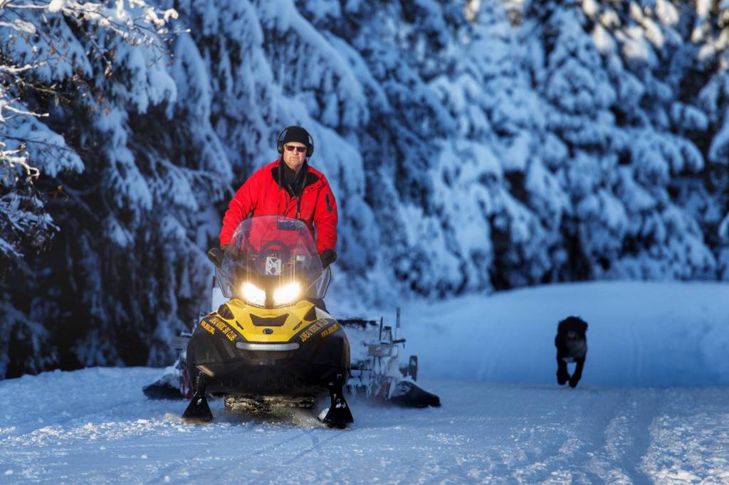 Juneau Nordic Ski Club volunteer Doug Sturm sets a cross-country ski track as his dog Jamie follows along on Montana Creek Road on Wednesday, Dec. 26, 2018. (Michael Penn | Juneau Empire)