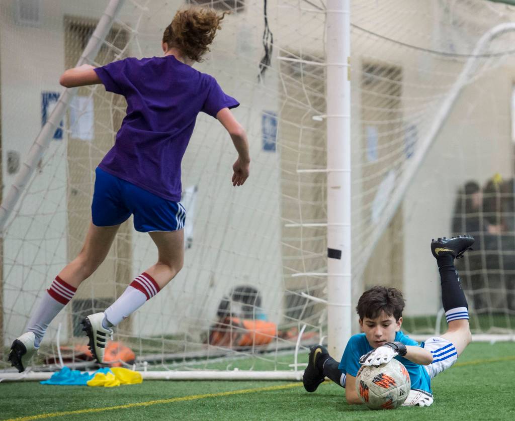Grumpsicles play against Gone Skiing at the annual Holiday Cup Soccer Tournament at the Wells Fargo Dimond Park Field House on Wednesday, Dec. 26, 2018. (Michael Penn | Juneau Empire)