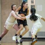 Barrows Jenilee Donovan, center, is pressured by Easts Skye Miller, left, and Angelika Aguirre at the Princess Cruises Capital City Classic at Juneau-Douglas High School on Thursday, Dec. 27, 2018. East won 48-43. (Michael Penn | Juneau Empire)