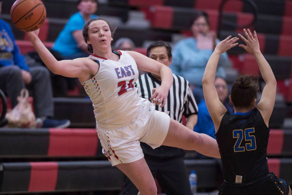 Easts Skye Miller passes the ball around Barrows Jordan Ahgeak at the Princess Cruises Capital City Classic at Juneau-Douglas High School on Thursday, Dec. 27, 2018. East won 48-43. (Michael Penn | Juneau Empire)