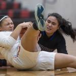 Easts Amari Brown, left, and Barrows Trinity Manu battle for a loose ball at the Princess Cruises Capital City Classic at Juneau-Douglas High School on Thursday, Dec. 27, 2018. (Michael Penn | Juneau Empire)