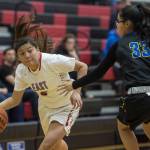 Easts Jayla Jordan, left, drives against Barrows Caitlyn Brower at the Princess Cruises Capital City Classic at Juneau-Douglas High School on Thursday, Dec. 27, 2018. (Michael Penn | Juneau Empire)