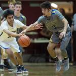 Barrows Kainoa Texeira, left, has the ball stolen by Maine-Endwells Santino Aybar at the Princess Cruises Capital City Classic at Juneau-Douglas High School on Thursday, Dec. 27, 2018. Barrow won 73-69. (Michael Penn | Juneau Empire)