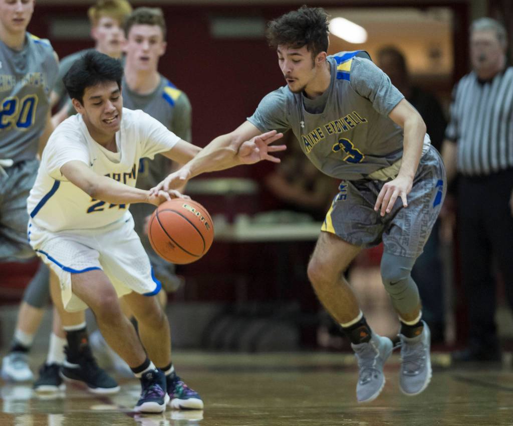 Barrows Kainoa Texeira, left, has the ball stolen by Maine-Endwells Santino Aybar at the Princess Cruises Capital City Classic at Juneau-Douglas High School on Thursday, Dec. 27, 2018. Barrow won 73-69. (Michael Penn | Juneau Empire)