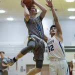 Maine-Endwells Gannon Russell, left, goes up for a shoot against Barrows Jefferson Nobleza at the Princess Cruises Capital City Classic at Juneau-Douglas High School on Thursday, Dec. 27, 2018. Barrow won 73-69. (Michael Penn | Juneau Empire)