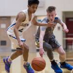 Barrows Karl Nobleza, left, and Maine-Endwells Jack Coleman battle for a loose ball at the Princess Cruises Capital City Classic at Juneau-Douglas High School on Thursday, Dec. 27, 2018. Barrow won 73-69. (Michael Penn | Juneau Empire)