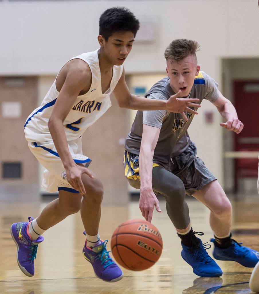 Barrows Karl Nobleza, left, and Maine-Endwells Jack Coleman battle for a loose ball at the Princess Cruises Capital City Classic at Juneau-Douglas High School on Thursday, Dec. 27, 2018. Barrow won 73-69. (Michael Penn | Juneau Empire)