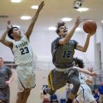 Maine-Endwells Matt Borne drives to the basket between Barrows Isiah Mongoyak, left, and Brendon Matthews at the Princess Cruises Capital City Classic at Juneau-Douglas High School on Thursday, Dec. 27, 2018. Barrow won 73-69. (Michael Penn | Juneau Empire)
