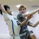 Maine-Endwells Gannon Russell, right, drives to the basket against Barrows Kainoa Texeira at the Princess Cruises Capital City Classic at Juneau-Douglas High School on Thursday, Dec. 27, 2018. Barrow won 73-69. (Michael Penn | Juneau Empire)