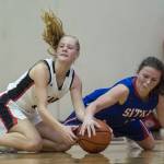 Juneau-Douglas Sadie Tuckwood, left, scrambles for the ball with Sitkas Tawny Smith at the Princess Cruises Capital City Classic at Juneau-Douglas High School on Thursday, Dec. 27, 2018. Juneau-Douglas won 52-25. (Michael Penn | Juneau Empire)