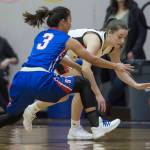 Juneau-Douglas Kiana Potter, right, is pressured by Sitkas Tiffany Elefante at the Princess Cruises Capital City Classic at Juneau-Douglas High School on Thursday, Dec. 27, 2018. Juneau-Douglas won 52-25. (Michael Penn | Juneau Empire)