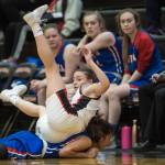 Juneau-Douglas Kiana Potter rolls over Sitkas Tiffany Elefante in a chase for the ball at the Princess Cruises Capital City Classic at Juneau-Douglas High School on Thursday, Dec. 27, 2018. Juneau-Douglas won 52-25. (Michael Penn | Juneau Empire)