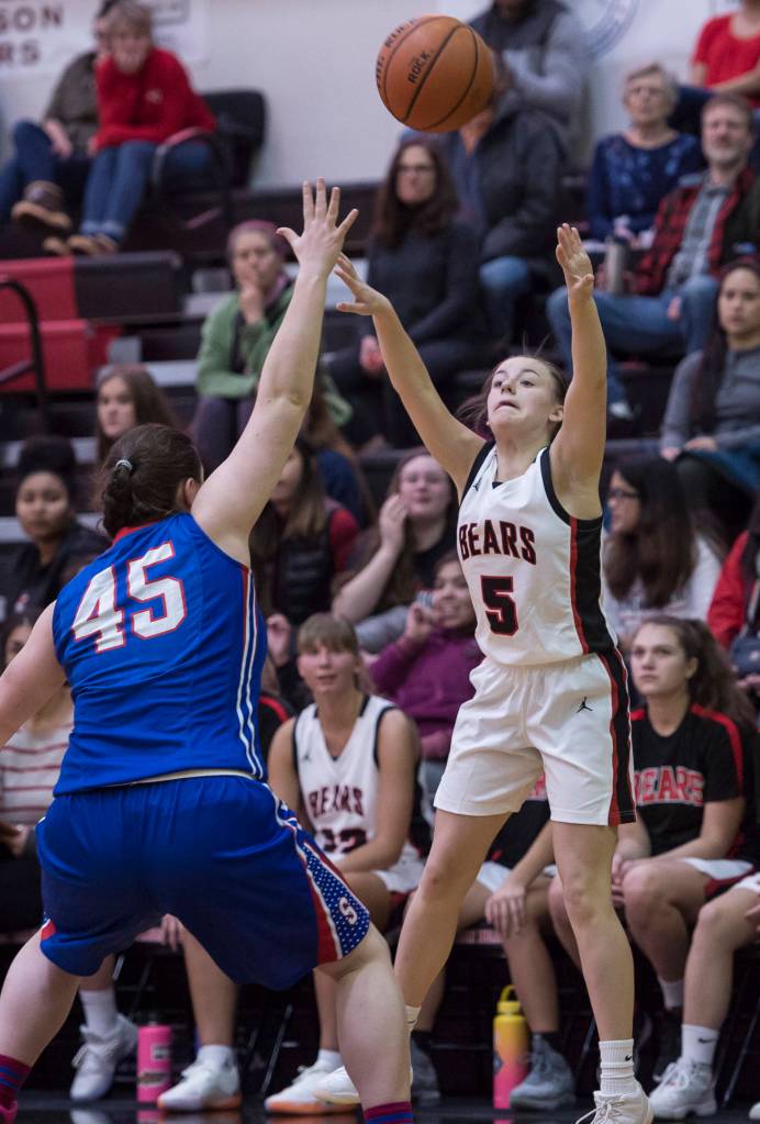 Juneau-Douglas Kiana Potter shoots over Sitkas Jessica Davis at the Princess Cruises Capital City Classic at Juneau-Douglas High School on Thursday, Dec. 27, 2018. Juneau-Douglas won 52-25. (Michael Penn | Juneau Empire)