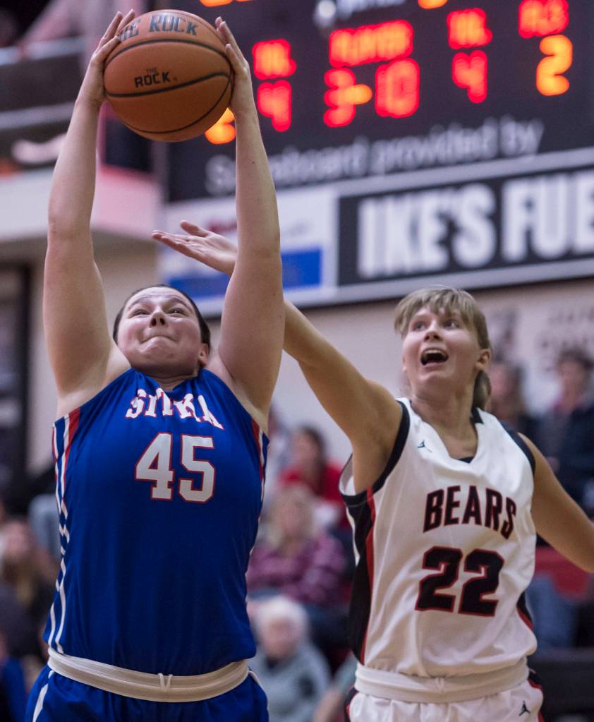 Sitkas Jessica Davis pulls in a rebound against Juneau-Douglas Caitlin Pusich at the Princess Cruises Capital City Classic at Juneau-Douglas High School on Thursday, Dec. 27, 2018. Juneau-Douglas won 52-25. (Michael Penn | Juneau Empire)