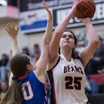 Juneau-Douglas Chloe McAdams shoots over Sitkas Shaye Jensen at the Princess Cruises Capital City Classic at Juneau-Douglas High School on Thursday, Dec. 27, 2018. Juneau-Douglas won 52-25. (Michael Penn | Juneau Empire)