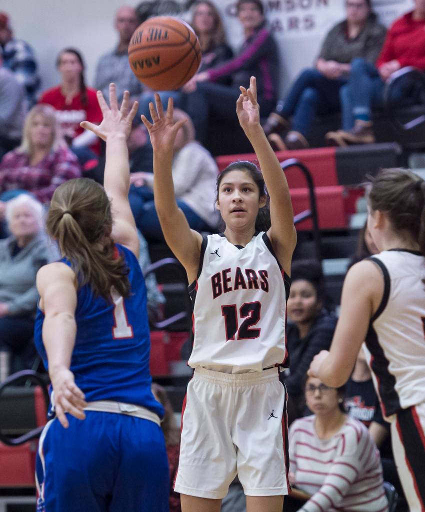 Juneau-Douglas Trinity Jackson shoots over Sitkas Tawny Smith at the Princess Cruises Capital City Classic at Juneau-Douglas High School on Thursday, Dec. 27, 2018. Juneau-Douglas won 52-25. (Michael Penn | Juneau Empire)