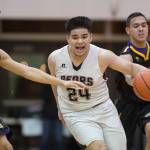 Juneau-Douglas Phillip Gonzales, center, drives between Lathrops Damian Correa, left, and Jhon Rones at the Princess Cruises Capital City Classic at Juneau-Douglas High School on Thursday, Dec. 27, 2018. Juneau-Douglas won 69-45. (Michael Penn | Juneau Empire)