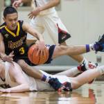 Lathrops Jhon Rones lands on Juneau-Douglas Tad Watson during a loose ball at the Princess Cruises Capital City Classic at Juneau-Douglas High School on Thursday, Dec. 27, 2018. Juneau-Douglas won 69-45. (Michael Penn | Juneau Empire)
