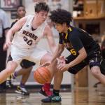 Juneau-Douglas Cooper Kriegmont, left, keeps pressure on Lathrops Tyriq Luke at the Princess Cruises Capital City Classic at Juneau-Douglas High School on Thursday, Dec. 27, 2018. Juneau-Douglas won 69-45. (Michael Penn | Juneau Empire)