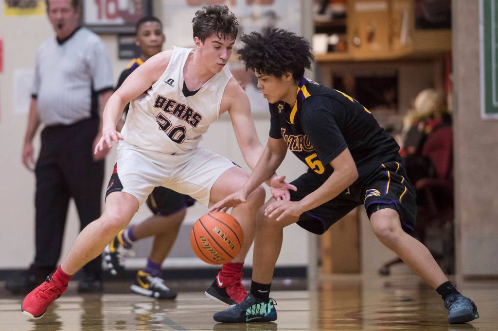 Juneau-Douglas Cooper Kriegmont, left, keeps pressure on Lathrops Tyriq Luke at the Princess Cruises Capital City Classic at Juneau-Douglas High School on Thursday, Dec. 27, 2018. Juneau-Douglas won 69-45. (Michael Penn | Juneau Empire)