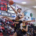 Juneau-Douglas Israel Yadao lays the ball up over Lathrops Jakobee Johnson at the Princess Cruises Capital City Classic at Juneau-Douglas High School on Thursday, Dec. 27, 2018. Juneau-Douglas won 69-45. (Michael Penn | Juneau Empire)
