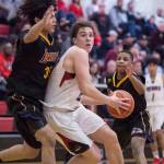 Juneau-Douglas Cooper Kriegmont, center, drives the basket between Lathrops Tyriq Luke, left, and Jakobee Johnson at the Princess Cruises Capital City Classic at Juneau-Douglas High School on Thursday, Dec. 27, 2018. Juneau-Douglas won 69-45. (Michael Penn | Juneau Empire)