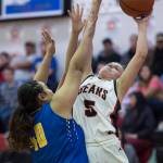 Juneau-Douglas Kiana Potter, right, shoots against Barrows Victoria Elkins at the Princess Cruises Capital City Classic at Juneau-Douglas High School on Friday, Dec. 28, 2018. (Michael Penn | Juneau Empire)