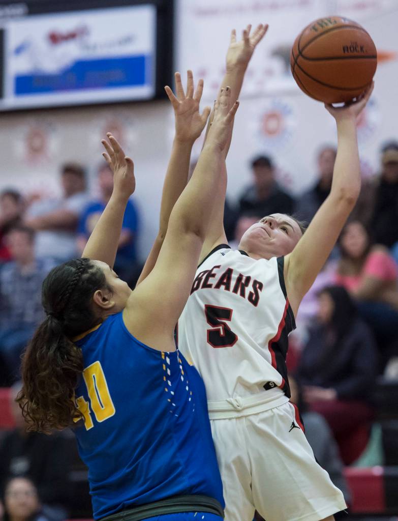 Juneau-Douglas Kiana Potter, right, shoots against Barrows Victoria Elkins at the Princess Cruises Capital City Classic at Juneau-Douglas High School on Friday, Dec. 28, 2018. (Michael Penn | Juneau Empire)