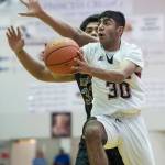 Juneau-Douglas Krishant Samtani shoots against Barrows Anthony Fruean at the Princess Cruises Capital City Classic at Juneau-Douglas High School on Friday, Dec. 28, 2018. Juneau-Douglas won 68-63. (Michael Penn | Juneau Empire)