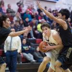 Juneau-Douglas Cooper Kriegmont drives between Barrows Brendon Matthews, left, and Isiah Mongoyak at the Princess Cruises Capital City Classic at Juneau-Douglas High School on Friday, Dec. 28, 2018. Juneau-Douglas won 68-63. (Michael Penn | Juneau Empire)