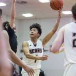 Juneau-Douglas Israel Yadao, left, shoots against Barrows Brendon Matthews at the Princess Cruises Capital City Classic at Juneau-Douglas High School on Friday, Dec. 28, 2018. Juneau-Douglas won 68-63. (Michael Penn | Juneau Empire)