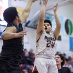 Juneau-Douglas Philip Gonzales, right, shoots against Barrows Anthony Fruean at the Princess Cruises Capital City Classic at Juneau-Douglas High School on Friday, Dec. 28, 2018. Juneau-Douglas won 68-63. (Michael Penn | Juneau Empire)