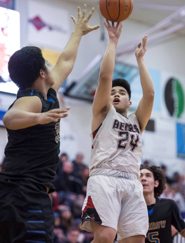 Juneau-Douglas Philip Gonzales, right, shoots against Barrows Anthony Fruean at the Princess Cruises Capital City Classic at Juneau-Douglas High School on Friday, Dec. 28, 2018. Juneau-Douglas won 68-63. (Michael Penn | Juneau Empire)