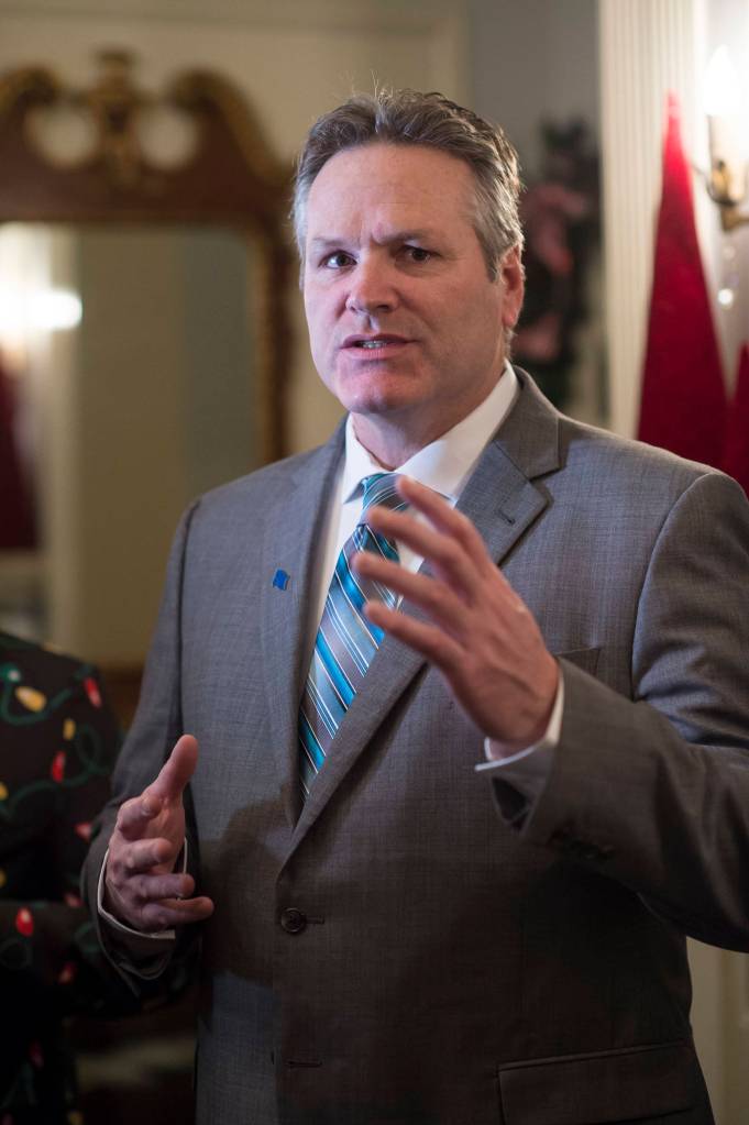Gov. Mike Dunleavy speaks to members of the media before welcoming Juneau residents to the Governors Open House on Tuesday, Dec. 11, 2018. (Michael Penn | Juneau Empire)