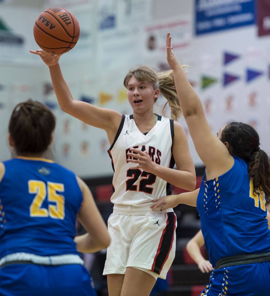 Juneau-Douglas Caitlin Pusich passes to a teammate against Barrow at the Princess Cruises Capital City Classic at Juneau-Douglas High School on Friday, Dec. 28, 2018. Juneau-Douglas won 66-46. (Michael Penn | Juneau Empire)
