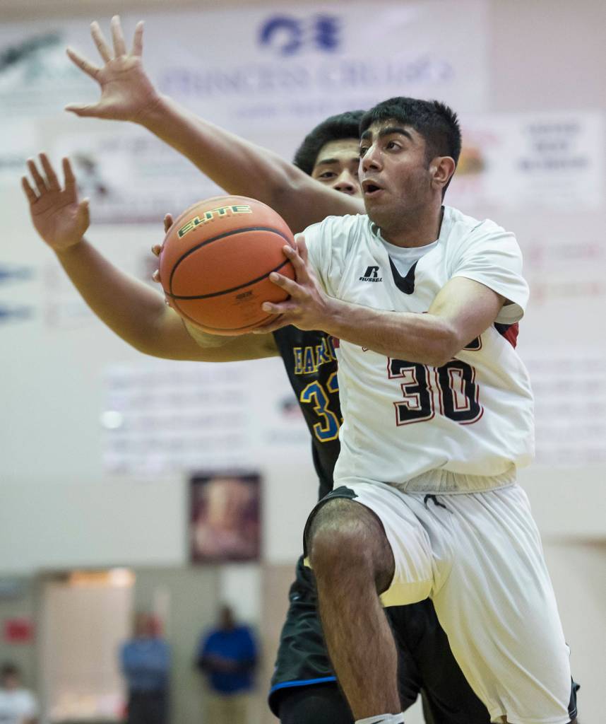 Juneau-Douglas Krishant Samtani shoots against Barrows Anthony Fruean at the Princess Cruises Capital City Classic at Juneau-Douglas High School on Friday, Dec. 28, 2018. Juneau-Douglas won 68-63. (Michael Penn | Juneau Empire)