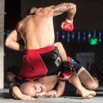 Terrence Wheat, blue shorts, takes on Jose Rodriquez in a MMA fight at the Beatdown #33 at the Elizabeth Peratrovich Hall on Friday, Dec. 28, 2018. Wheat won the match. (Michael Penn | Juneau Empire)