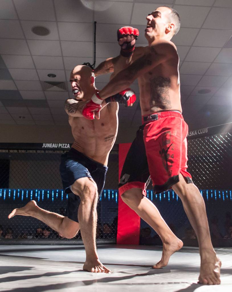 Terrence Wheat, left, charges Jose Rodriquez during their MMA fight at the Beatdown 33 at the Elizabeth Peratrovich Hall on Friday, Dec. 28, 2018. Wheat won the match. (Michael Penn | Juneau Empire)