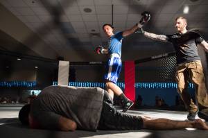 Seth Elisoff, center, celebrates his knockdown of Darrel Whisenant as referee Mike Shipman steps in during Beatdown 33 at the Elizabeth Peratrovich Hall on Friday, Dec. 28, 2018. Elisoff won the match. (Michael Penn | Juneau Empire)
