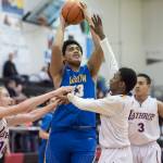 Barrows Anthony Fruean, center, goes up for a shot against Lathrops Jayce Johnson, left, and Mekhi Briggman at the Princess Cruises Capital City Classic at Juneau-Douglas High School on Saturday, Dec. 29, 2018. Barrow won 76-68. (Michael Penn | Juneau Empire)