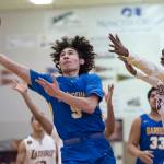 Barrows Brendon Matthews, left, shoots against Lathrops Mekhi Briggman at the Princess Cruises Capital City Classic at Juneau-Douglas High School on Saturday, Dec. 29, 2018. Barrow won 76-68. (Michael Penn | Juneau Empire)