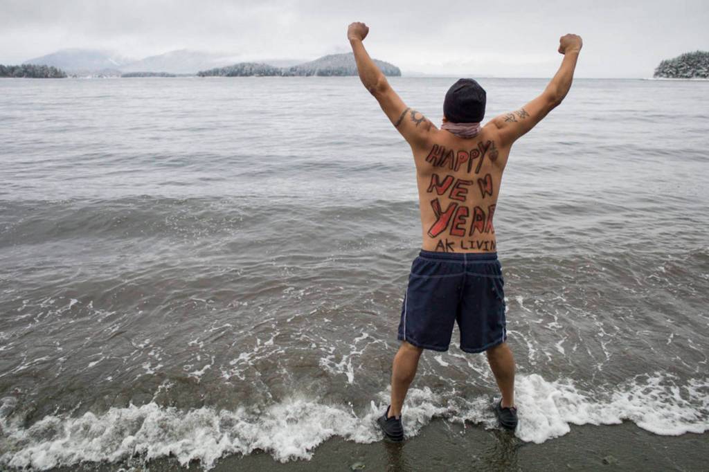 Marvin Pena steels himself for the annual Polar Bear Dip at Auke Recreation beach on Monday, Jan. 1, 2018. (Michael Penn | Juneau Empire File)