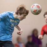 Iced Out, blue, competes against Naughty List, red, in the finals of the high school division at the annual Holiday Cup Soccer Tournament at the Wells Fargo Dimond Park Field House on Monday, Dec. 31, 2018. Iced Out won 8-2. (Michael Penn | Juneau Empire)