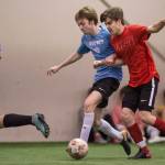 Iced Out, blue, competes against Naughty List, red, in the finals of the high school division at the annual Holiday Cup Soccer Tournament at the Wells Fargo Dimond Park Field House on Monday, Dec. 31, 2018. Iced Out won 8-2. (Michael Penn | Juneau Empire)