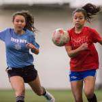 Iced Out, blue, competes against Naughty List, red, in the finals of the high school division at the annual Holiday Cup Soccer Tournament at the Wells Fargo Dimond Park Field House on Monday, Dec. 31, 2018. Iced Out won 8-2. (Michael Penn | Juneau Empire)