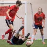 Iced Out, blue, competes against Naughty List, red, in the finals of the high school division at the annual Holiday Cup Soccer Tournament at the Wells Fargo Dimond Park Field House on Monday, Dec. 31, 2018. Iced Out won 8-2. (Michael Penn | Juneau Empire)